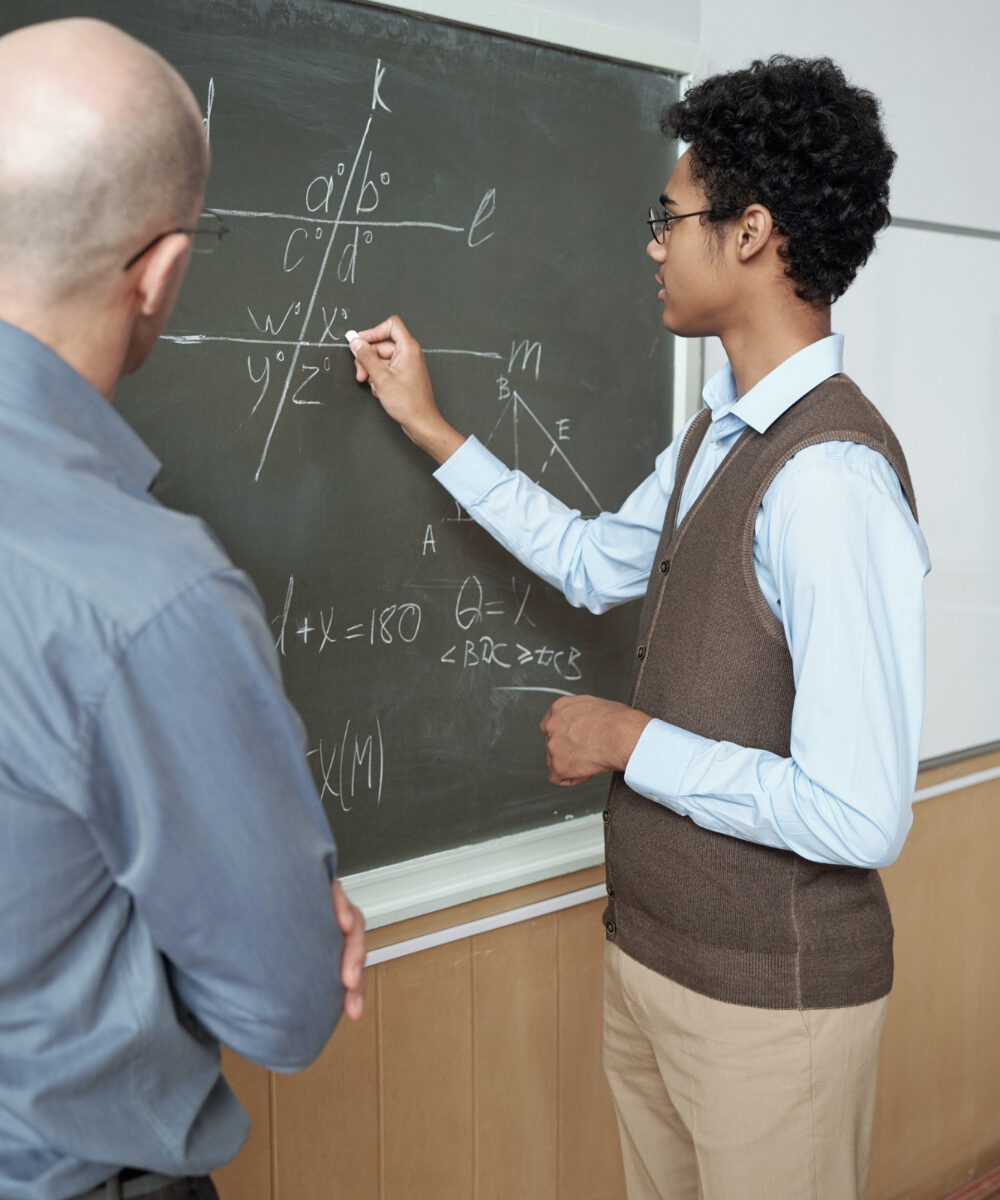teacher-listening-explanation-student-by-blackboard.jpg
